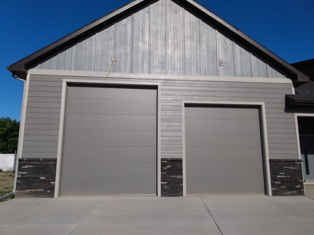 Gray commercial garage door installed by Alpha Overhead Doors