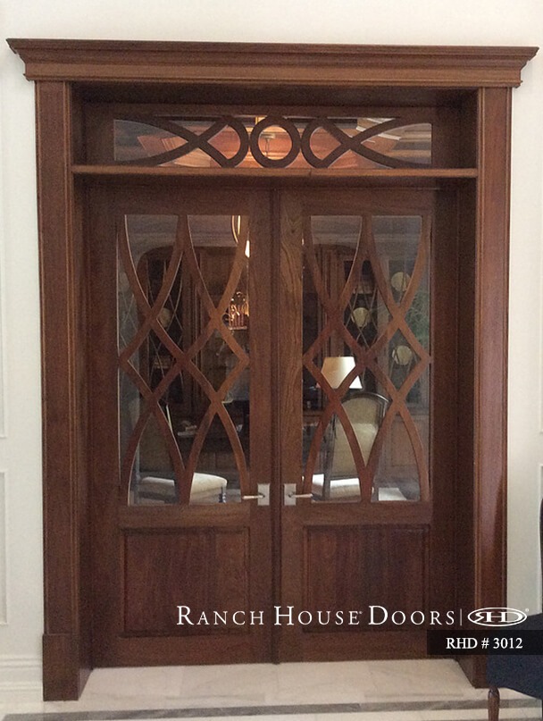 Custom wood entry door with decorative lines.